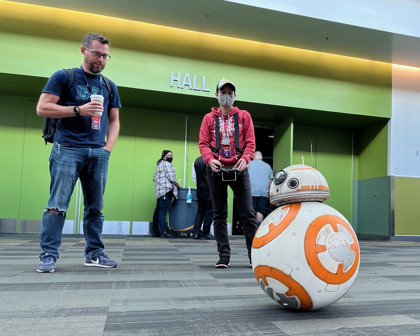 Riley admiring a remote-controlled BB-8 droid build at a convention