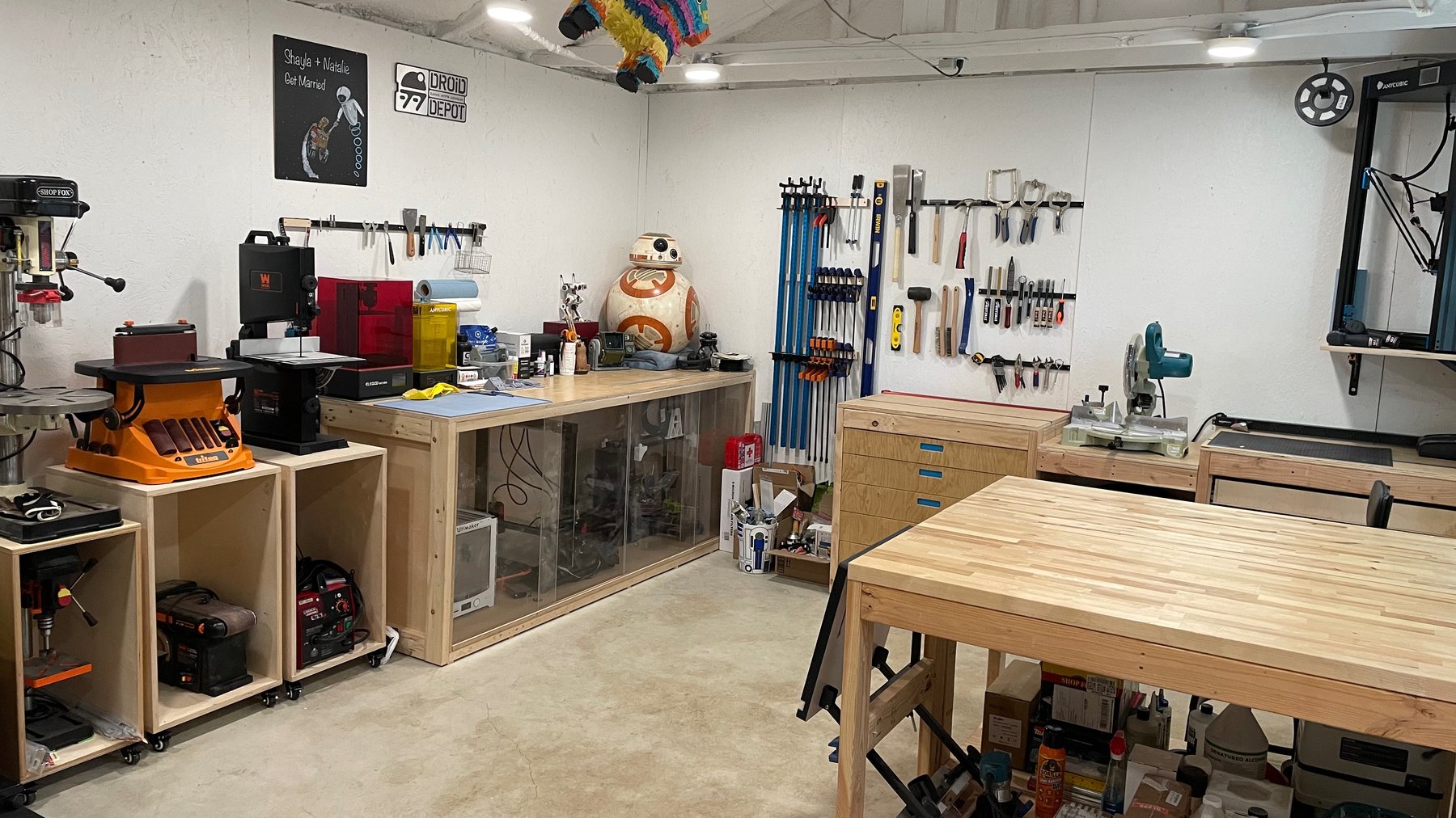 Riley's home workshop, full of tools, 3D printers, and an in-progress BB-8 build
